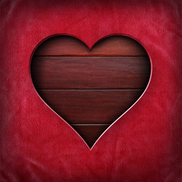 Heart shape cut out of red fabric on wood surface — Stock Photo, Image