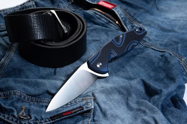 Knife, jeans and leather belt. Men's style. Casual style. — Stock Photo, Image