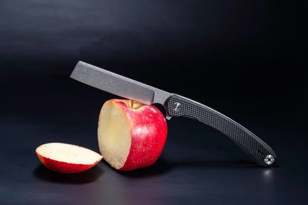 A knife cuts an apple. A slice of apple. A piece of chopped apple.