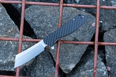 Karbon saplı cep bıçağı. Bıçak sapında bir desen var..