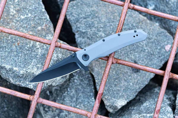 Pocket knife in the color of stone. Pocket knife for everyday carry. — Stock Photo, Image