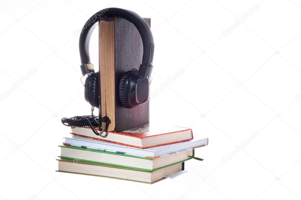 Listening to books through headphones. Listening to stories through books. Live book and headphones. Isolate.