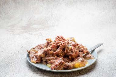 Tabak dolusu et. Konserve et ve yağ. Sadece bir tabak et. Açılı görünüm.