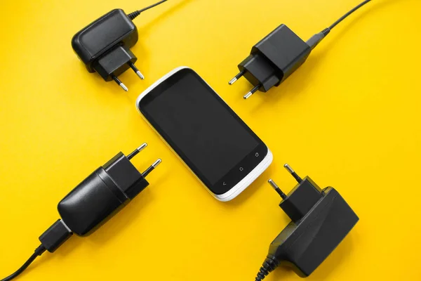 Wireless charging for smartphone on a yellow background, concept. — Stock Photo, Image