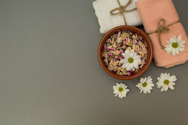 towels and flowers on a gray background