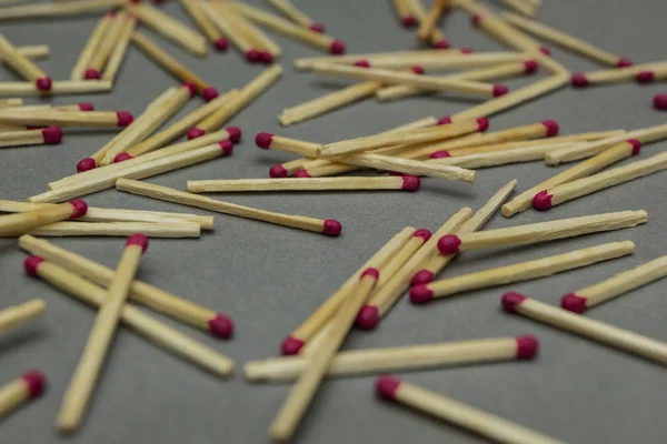 Scattered matches on a gray background — Stock Photo, Image