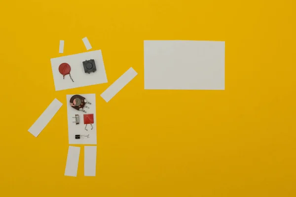 The robot holds a poster of paper