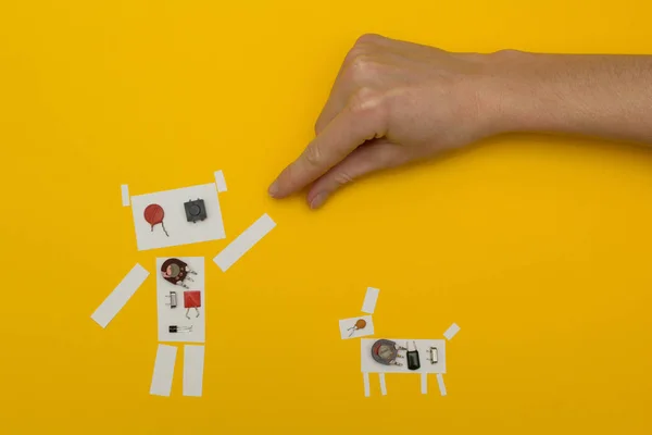 paper robot holding a man\'s hand