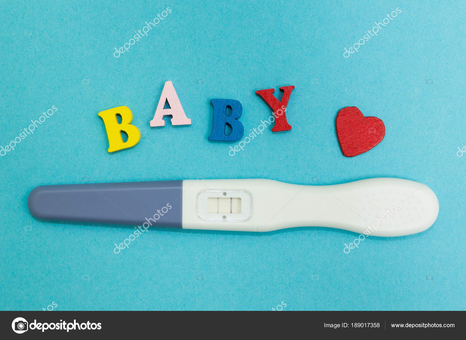 Positive pregnancy test with two strips and the word &ldquo;baby&rdquo; on a blue