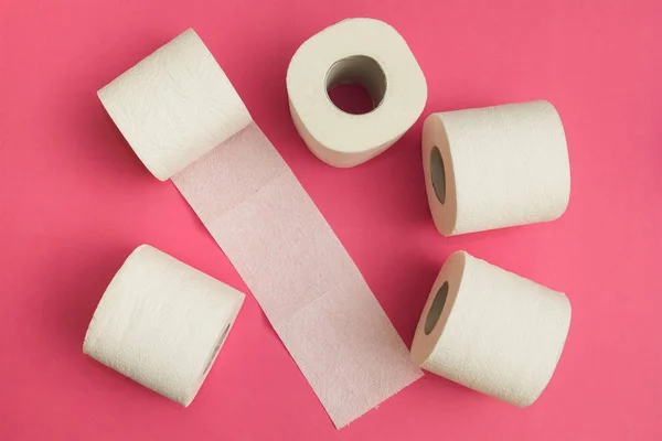 Rolos de papel higiênico branco em um fundo rosa . — Fotografia de Stock
