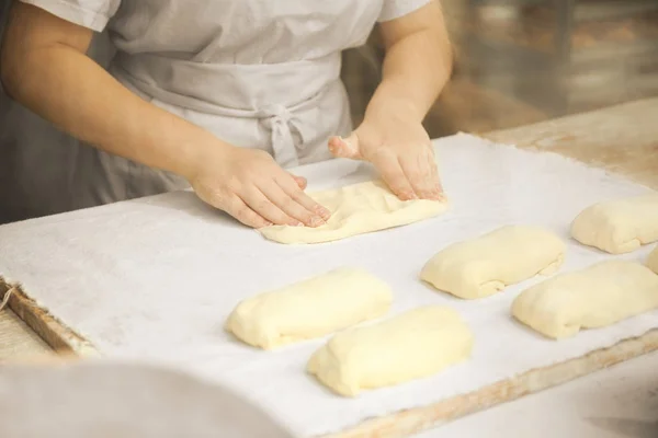 Świeże ciasto i mąka, ręce kucharza ugniatają pizzę lub ciasto. — Zdjęcie stockowe