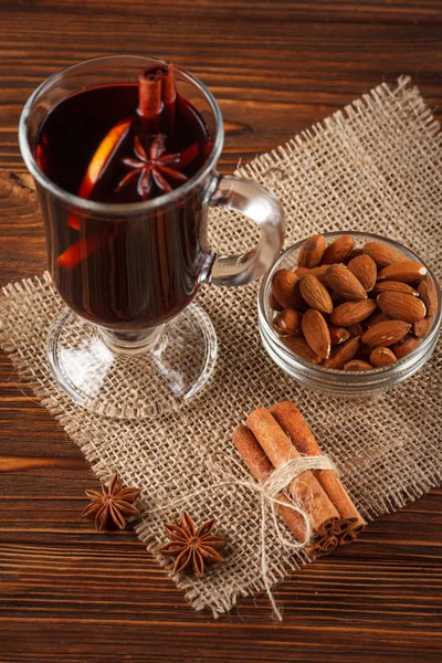 Winter horizontal mulled wine banner. Glasses with hot red wine and spices on wooden background.