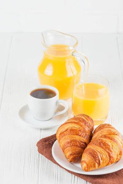 Freshly baked croissant, orange juice, fresh fruits, jam on white wooden background. French breakfast. Fresh pastries for morning. Delicious dessert. Closeup photography. Vertical banner — Stock Photo, Image