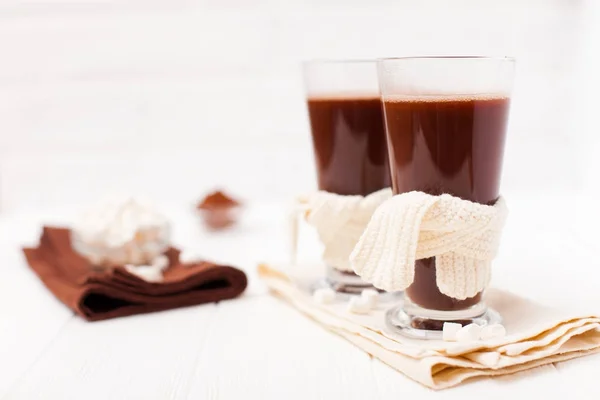 Warm cocoa in glasses with marshmallow, crocahet decorations, brown and beige napkins on white wooden background. Hot chocolate. Sweet drink. Close up photography. Hoizontal banner — Stock Photo, Image