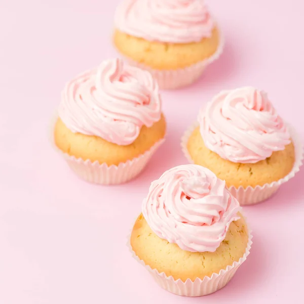 Cupcake decorated with pink buttercream on pastel pink background. Sweet beautiful cake. Square banner, greeting card for birthday, wedding, women's day. Close up photography. Selective focus — Stock Photo, Image