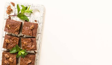 Brownie tatlı çikolata tatlı ceviz ve retro kurulu demek yapraklarda pastel bej renkli arka plan üzerinde kopya alanı ile.