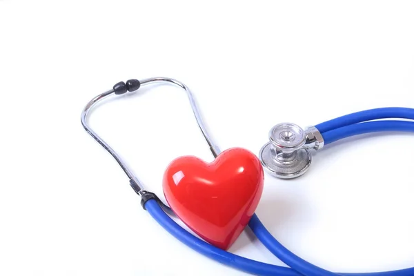 Heart with a medical stethoscope, isolated on wooden background — Stock Photo, Image