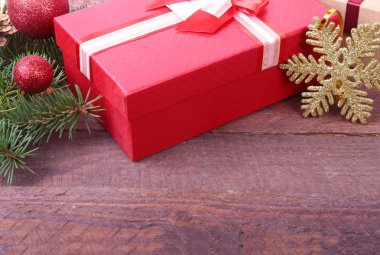 Ahşap arka plan üzerinde yay ve Noel dekorasyonu ile hediye kutuları