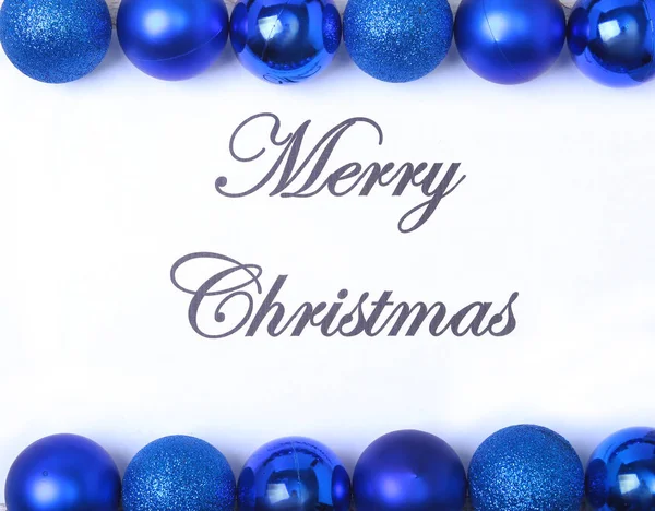 Text merry christmas on paper with many balls — Stock Photo, Image