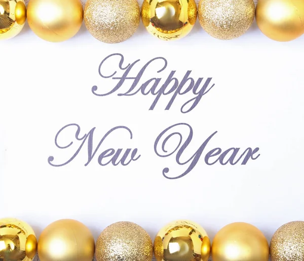 Texto feliz año nuevo en papel con muchas bolas — Foto de Stock