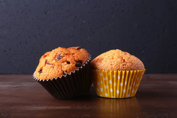 Tasty chocolate cupcakes, muffins on a white wooden table — Stock Photo, Image