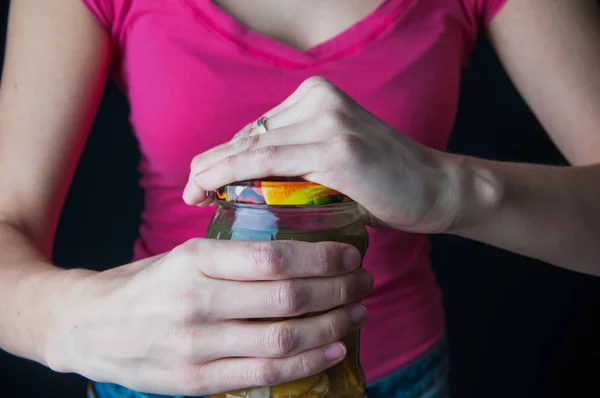 Bir kavanoz açmaya çalışan bir kadına