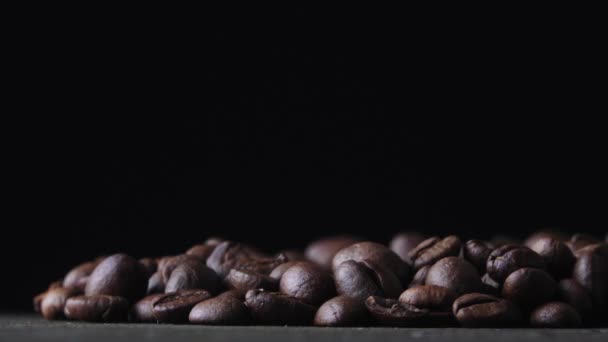Coffee beans spin on a dark background — Stock Video