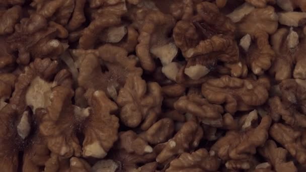 Walnut closeup. Walnut is crushed clockwise on a black background. Walnut closeup. Correctly the power on the conveyor moves. — Stock Video