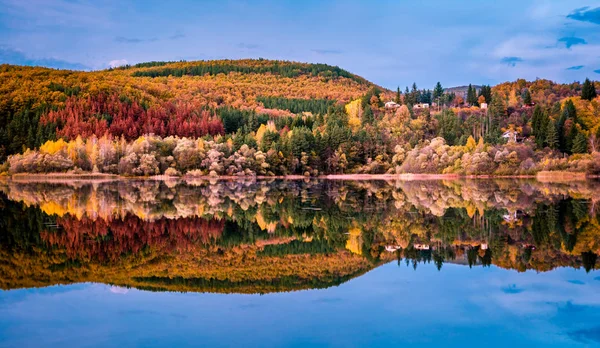 Stunning beautiful landscape of a lake Pasarel in Bulgaria, near Sofia city on a sunset with yellow and orange trees on a background and reflection in the water. — Stock Photo, Image