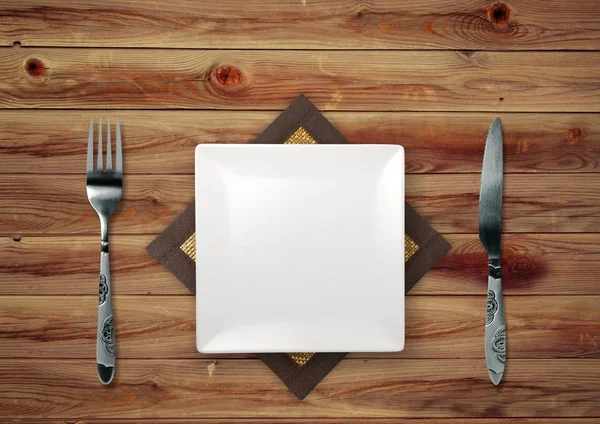 Wooden table with empty plate — Stock Photo, Image