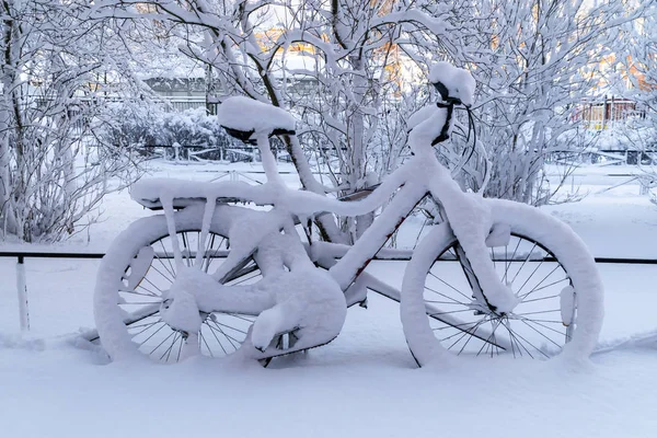 After a very heavy snowfall in the courtyard of Kronstadt remained snow-covered bike.