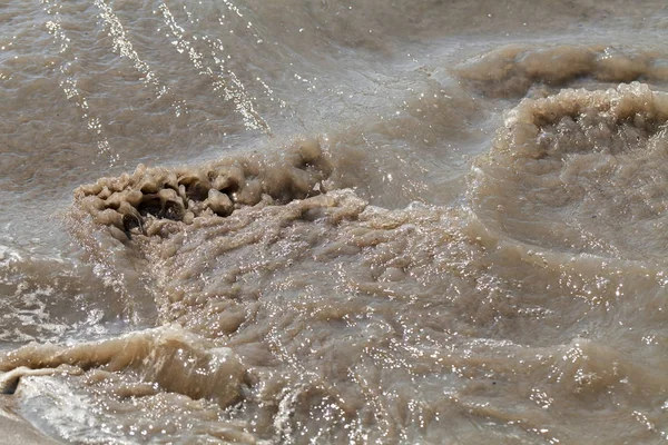 sand and mud in industrial water, note shallow depth of field