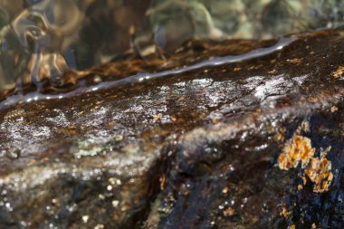 stone under the mountain water, note shallow depth of field
