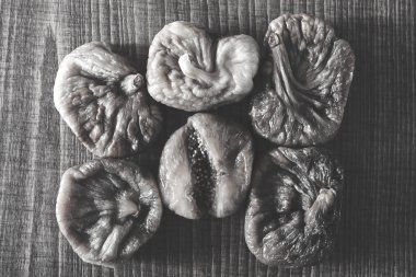 dried figs on a wooden table, note shallow depth of field