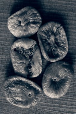 dried figs on a wooden table, note shallow depth of field