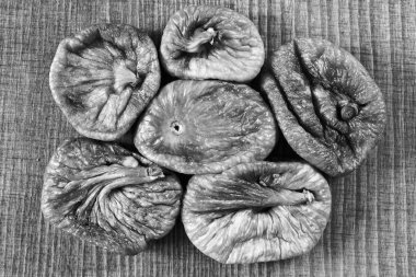 dried figs on a wooden table, note shallow depth of field
