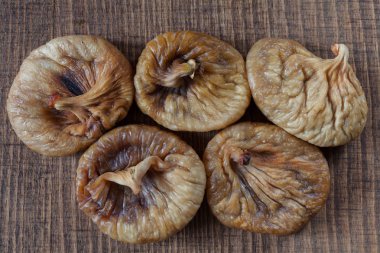 dried figs on a wooden table, note shallow depth of field