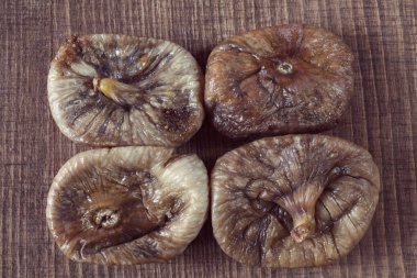 dried figs on a wooden table, note shallow depth of field