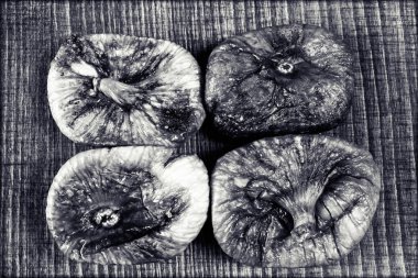 dried figs on a wooden table, note shallow depth of field