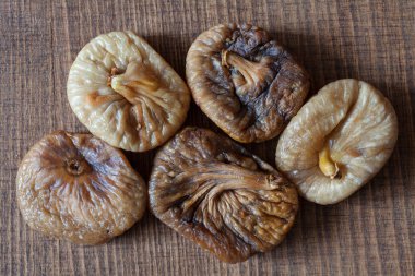 dried figs on a wooden table, note shallow depth of field