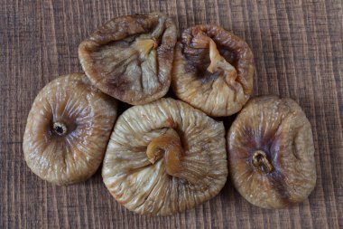 dried figs on a wooden table, note shallow depth of field