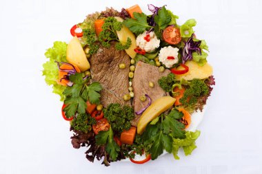 beef steak decorated with lots of vegetables