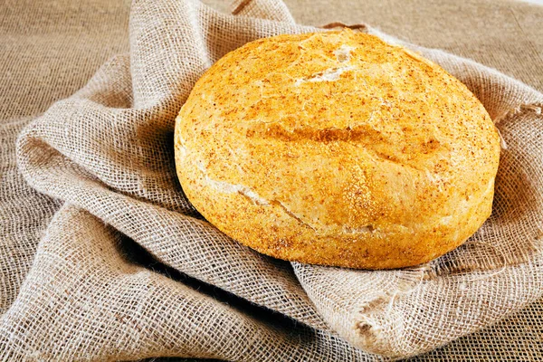 Round corn bread on a linen cloth, note shallow depth of field