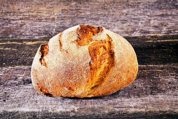round fresh homemade bread on a wooden board