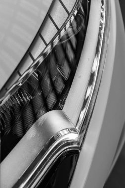 type headlights of the white vehicle, note shallow depth of field