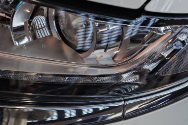 type headlights of the white vehicle, note shallow depth of field