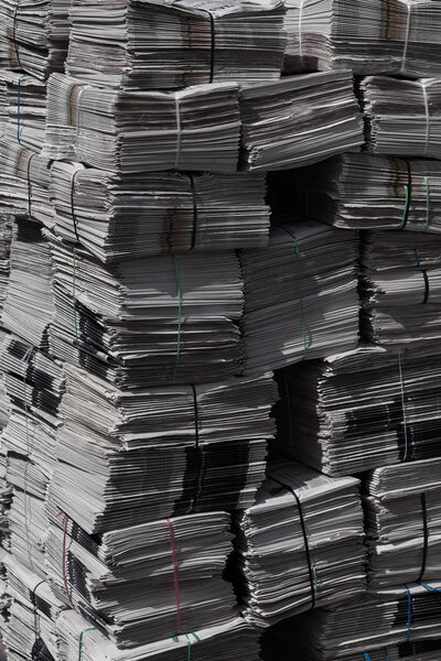 pile of newspapers for recycling in packages , note shallow depth of field