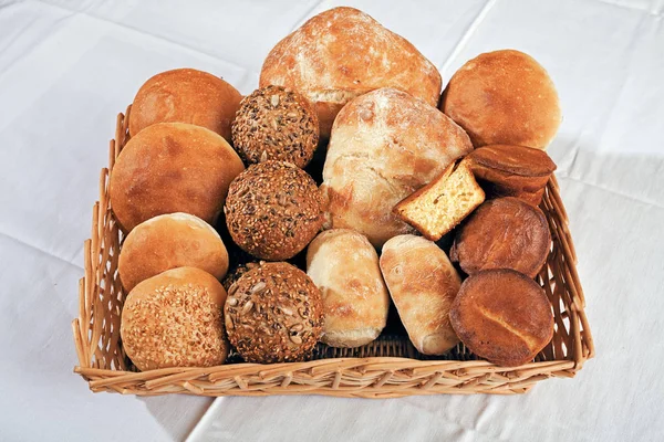 various kinds of bread  made from various flour in  a wicker basket