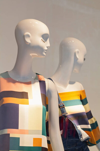 mannequins in a store window, note shallow depth of field