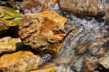 stone under the mountain water, note shallow depth of field